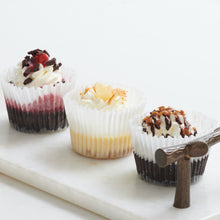 Load image into Gallery viewer, 3 assorted mini cheesecakes on decorative tray
