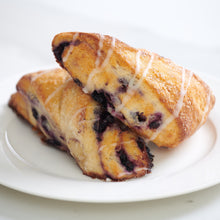Load image into Gallery viewer, 2 wild blueberry and lemon scones on plate
