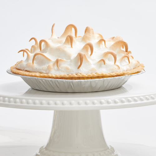 Lemon meringue pie placed on decorative stand