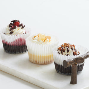 3 assorted mini cheesecakes on decorative tray